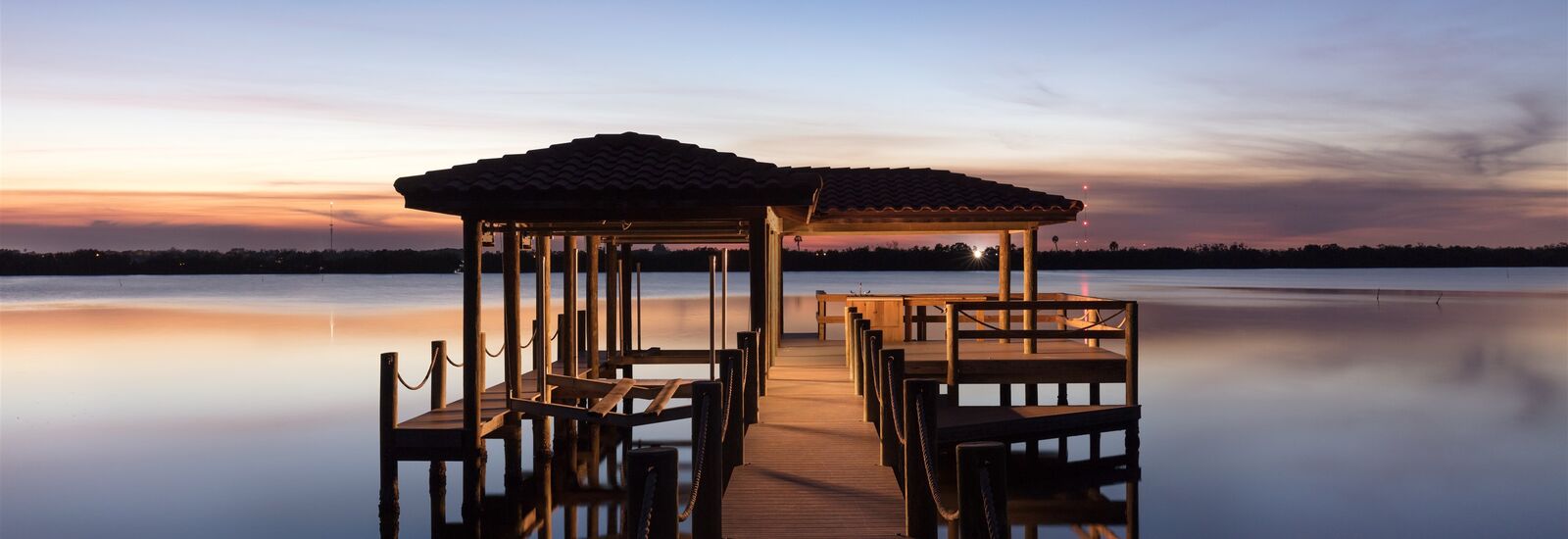 Dock on a lake at sunset